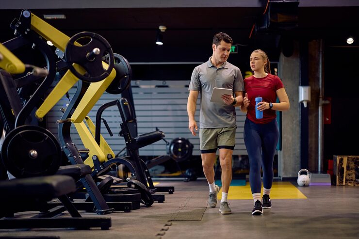 Athletic Woman Her Personal Trainer Walking Through Gym 1326977 17481